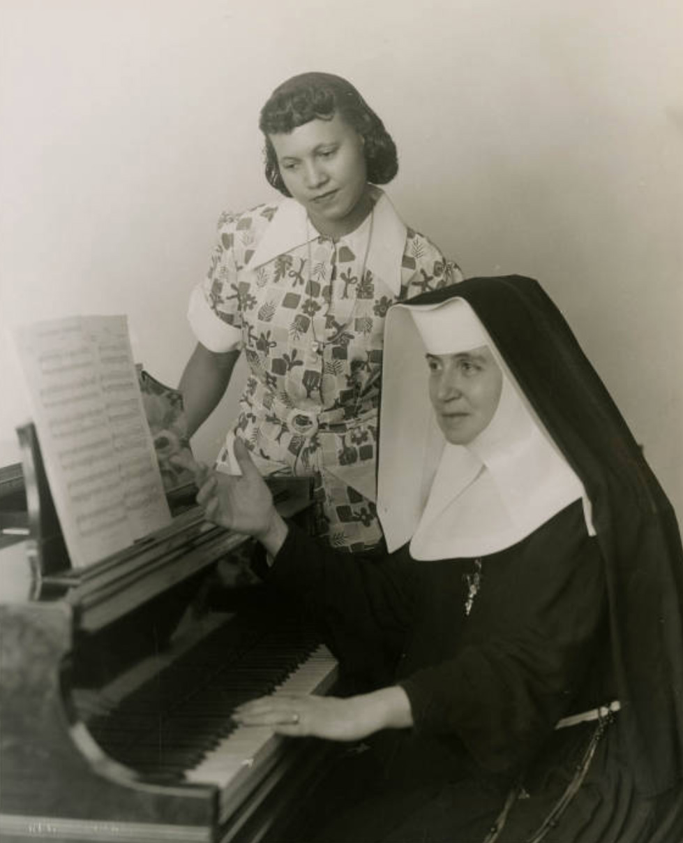 Sister Mary Elise Sisson teaches a Xavier student at the piano